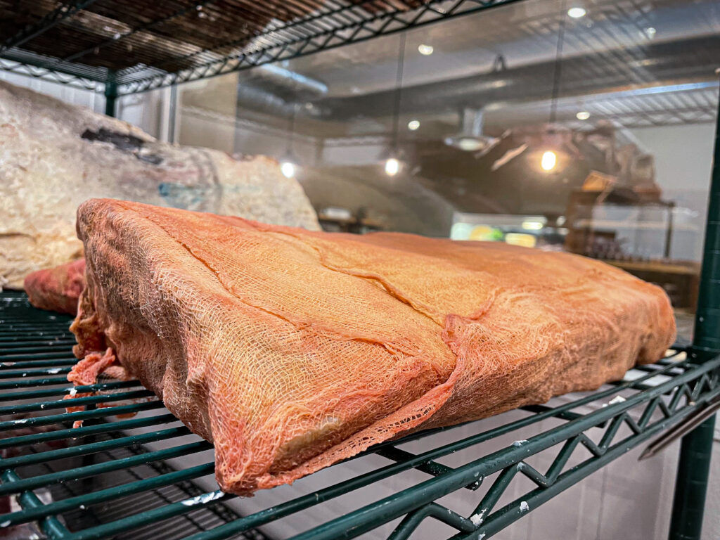 Whiskey aged beef in an aging vault on a rack